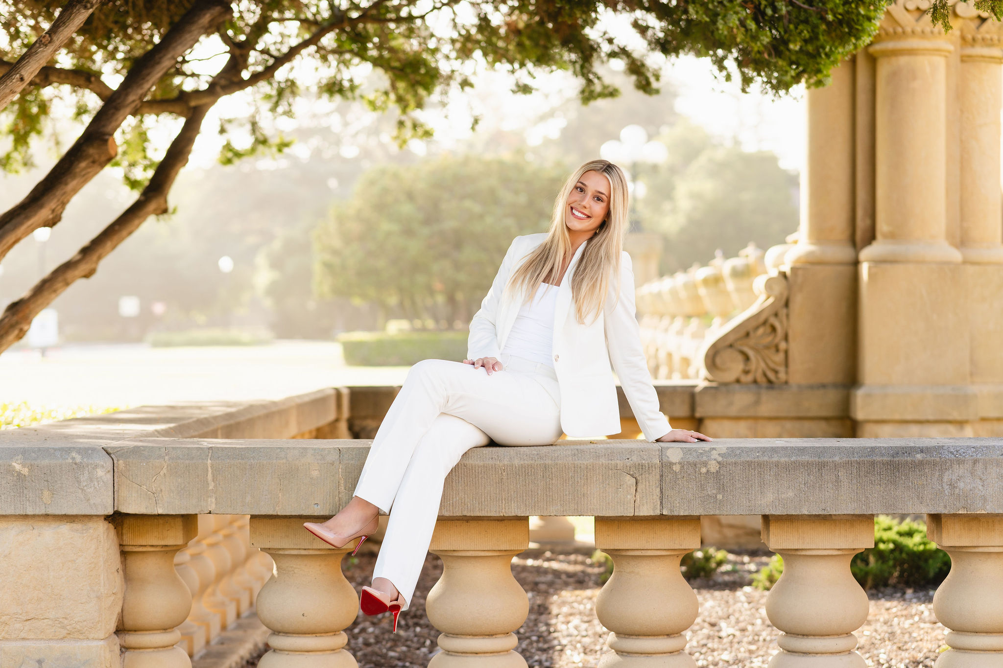 woman in white suit posing at stanford university