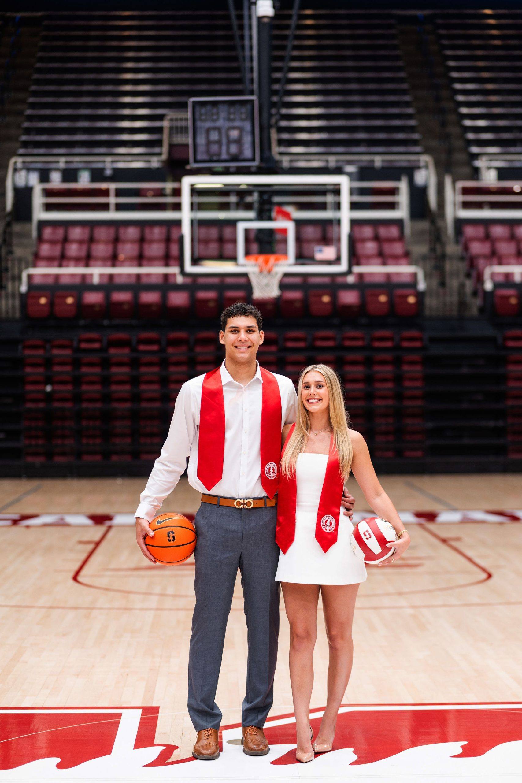 boyfriend holding a basketball while girlfriend holds a volley ball